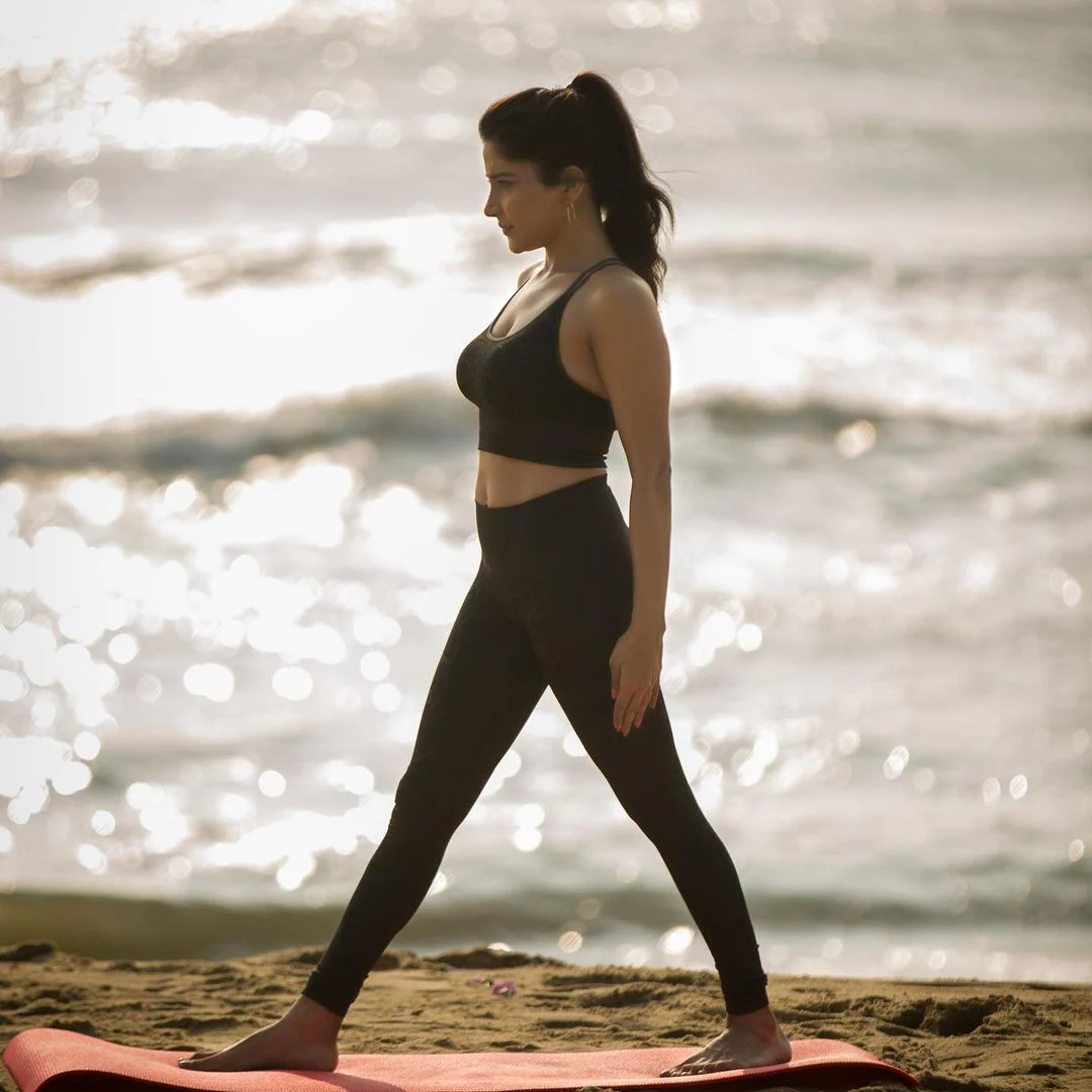 Actress sakshi agarwal hot photos in yoga dress along beach seashore