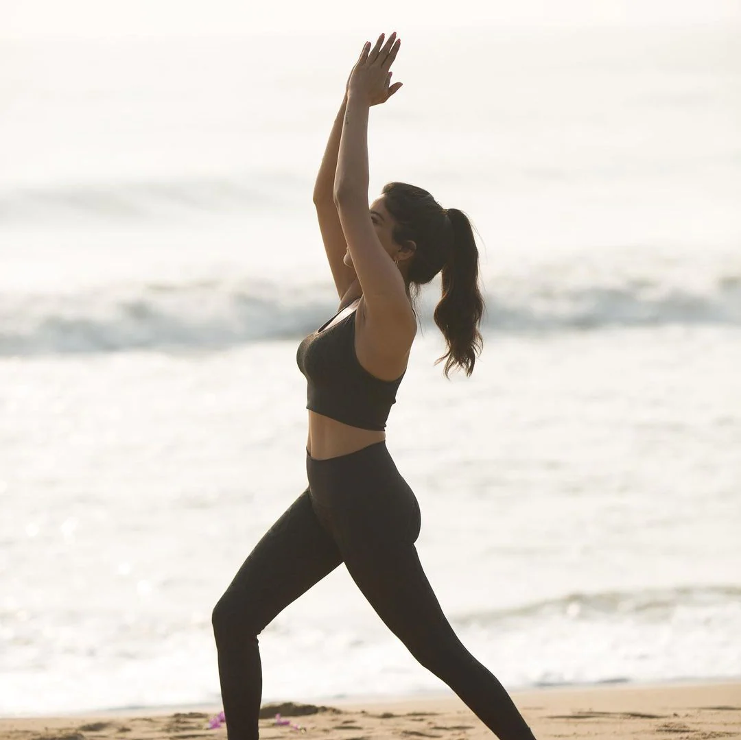 Actress sakshi agarwal hot photos in yoga dress along beach seashore