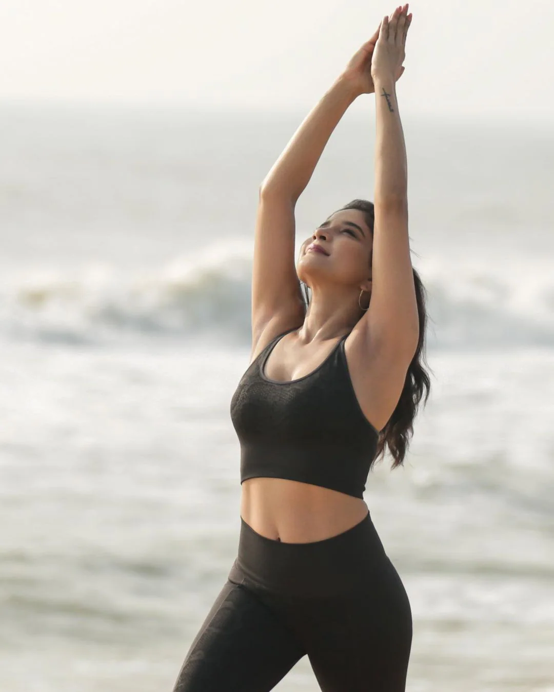 Actress sakshi agarwal hot photos in yoga dress along beach seashore