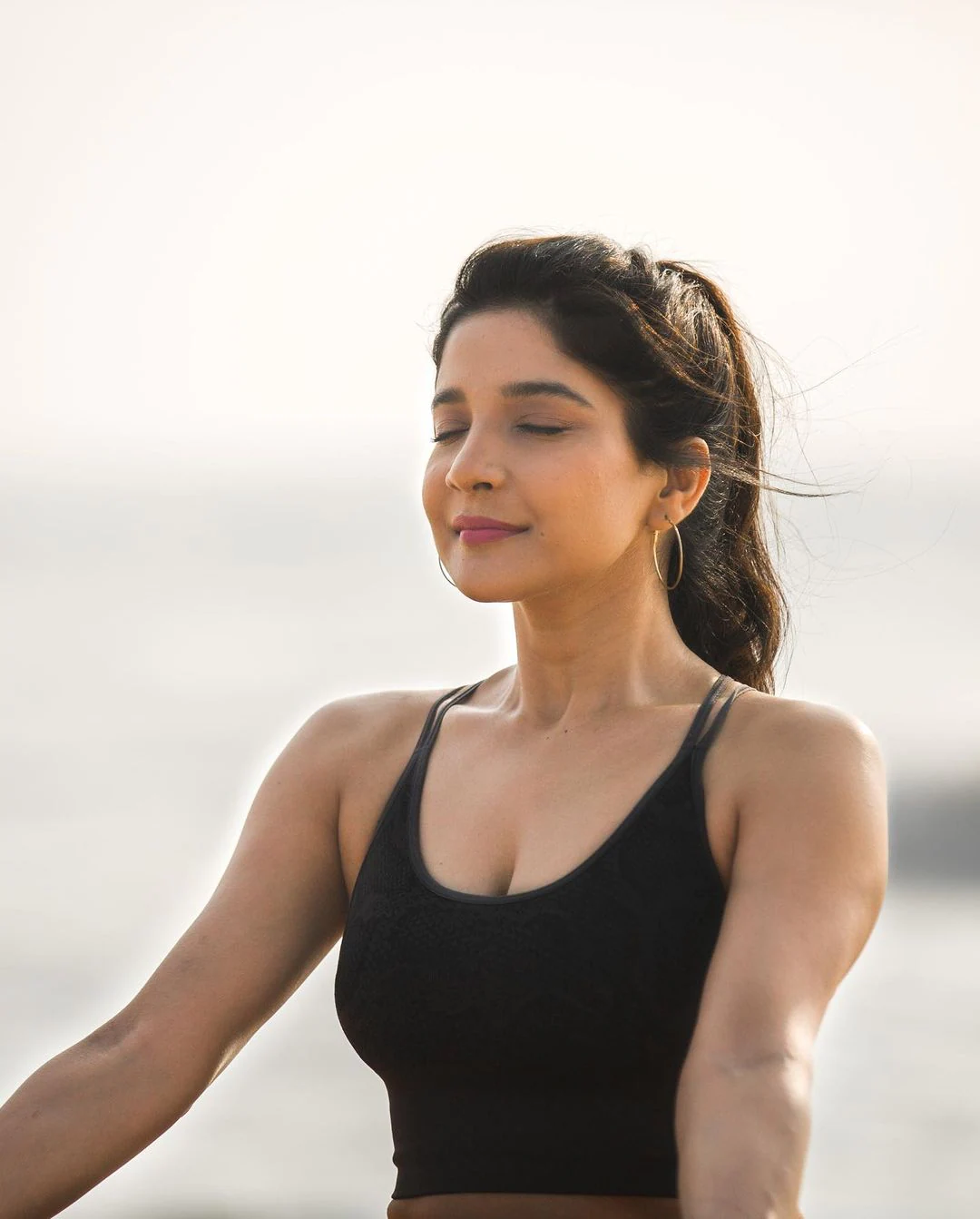 Actress sakshi agarwal hot photos in yoga dress along beach seashore