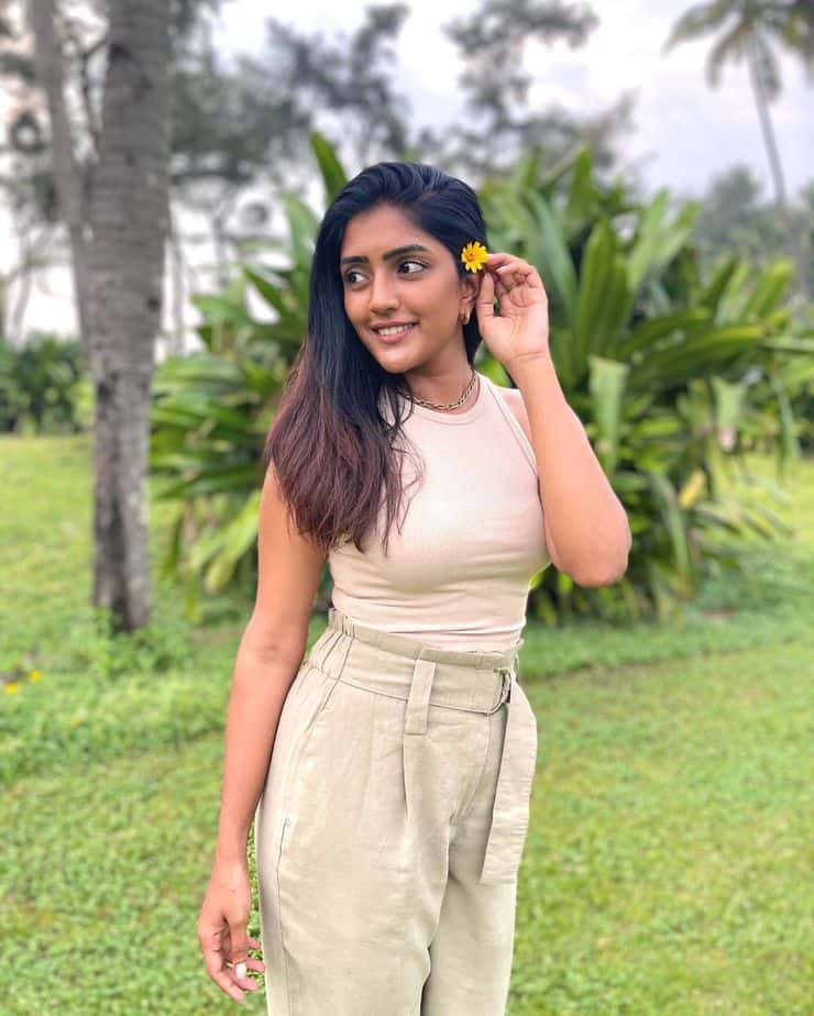 Actress eesha rebba hot photos holding flower in lips