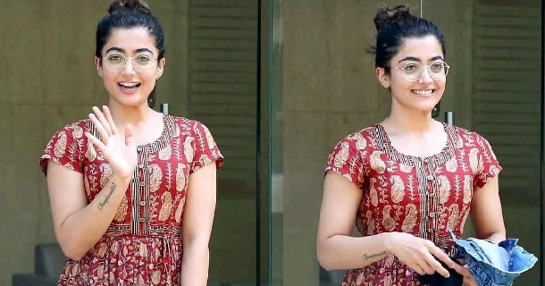 Actress rashmika mandanna hot photos in yellow colour single top seated on chair