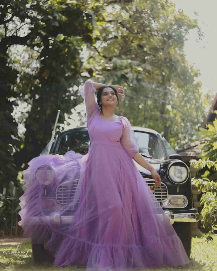 Ramya nambeesan posing inside car in lavendar colour gown