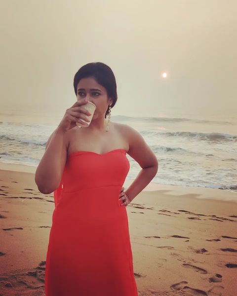 Poonam bajwa posing along seashore in hot sleeveless red dress