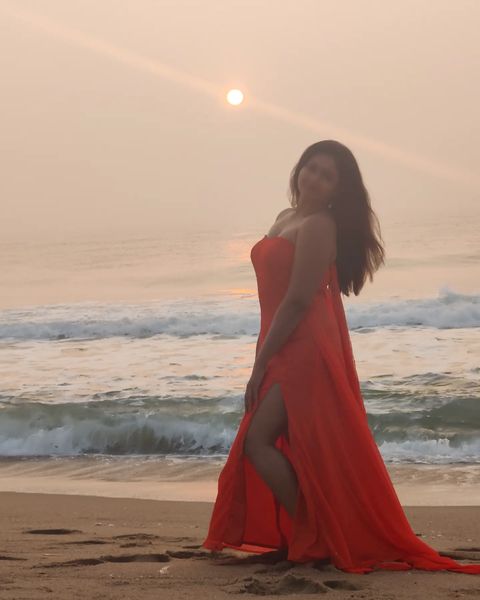 Poonam bajwa posing along seashore in hot sleeveless red dress