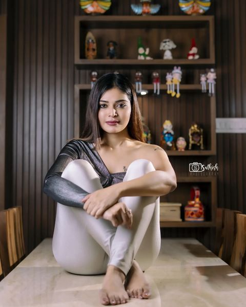 Dharsha gupta latest photoshoot sitting on dining table