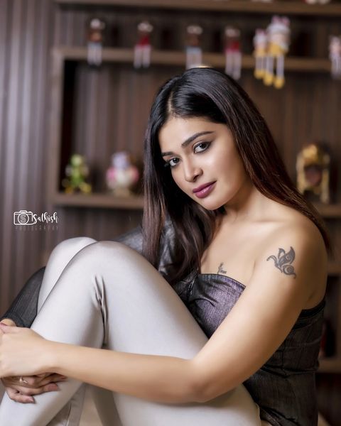 Dharsha gupta latest photoshoot sitting on dining table