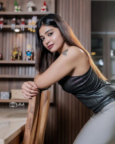 Dharsha gupta latest photoshoot sitting on dining table