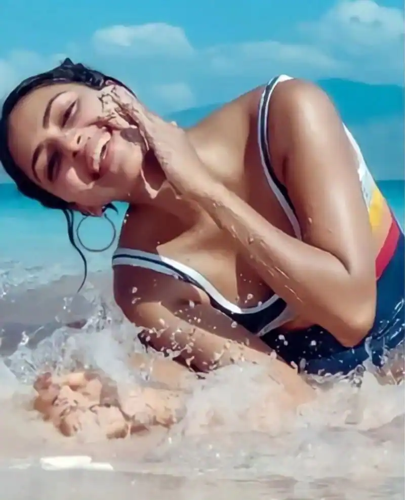 Amala paul photoshoot in beach sand and playing with waves