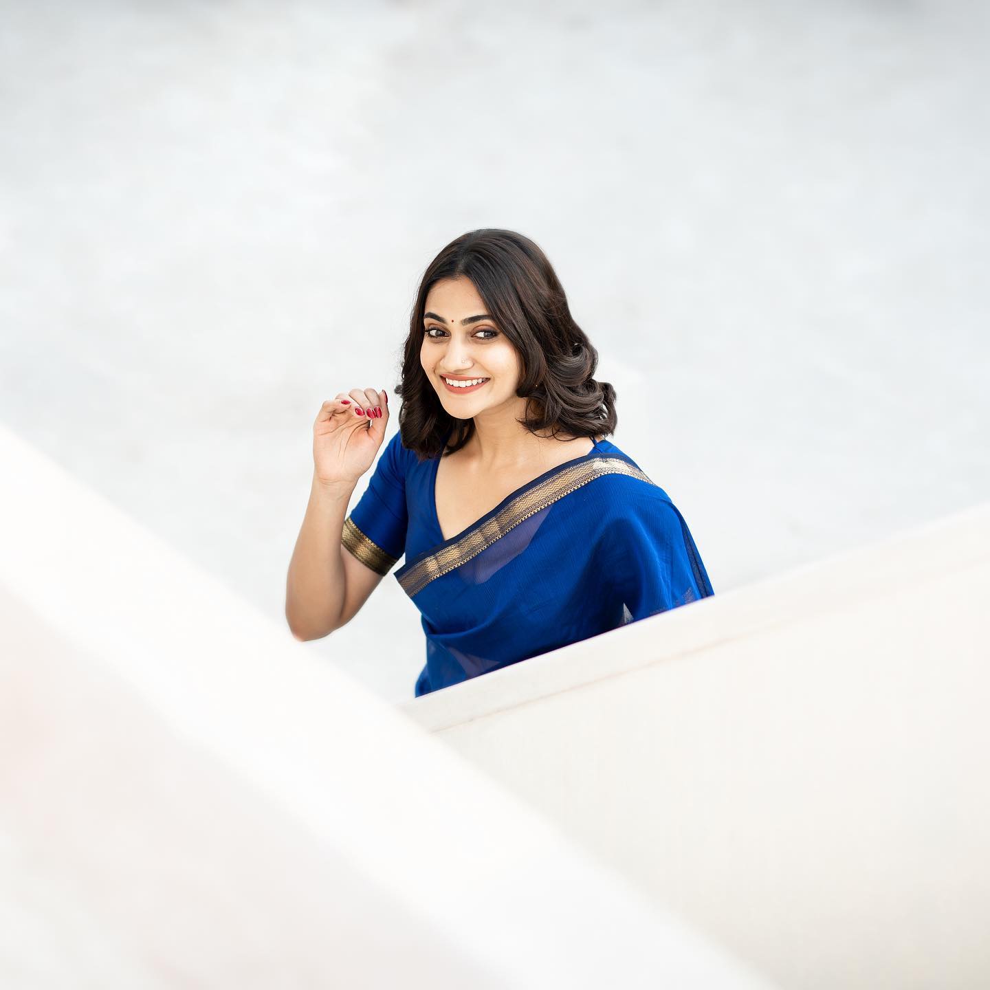 Losliya hot photos in blue colour saree and back open blouse