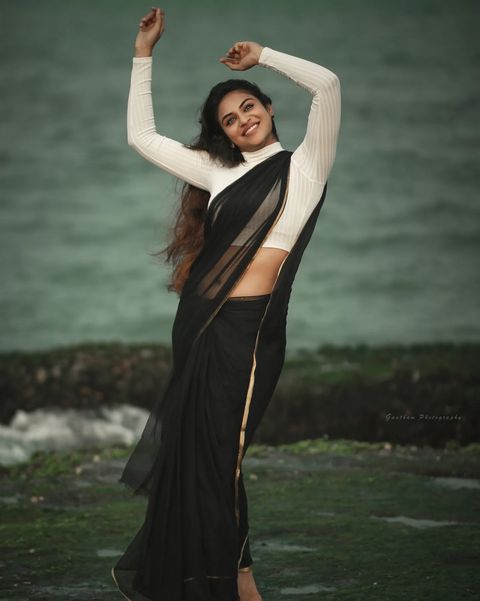 Indhuja ravichandran posing in black colour transparent saree getting viral