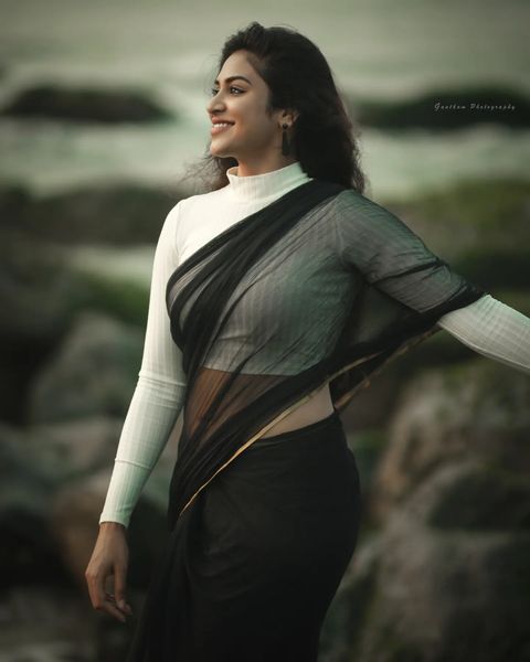 Indhuja ravichandran posing in black colour transparent saree getting viral