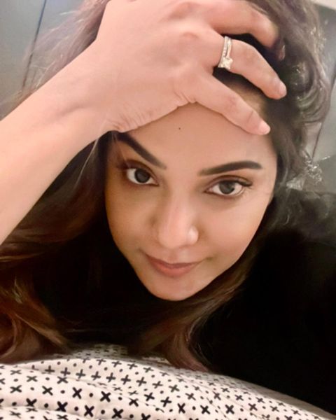 Aathmika hot photos in close up expressions on bed