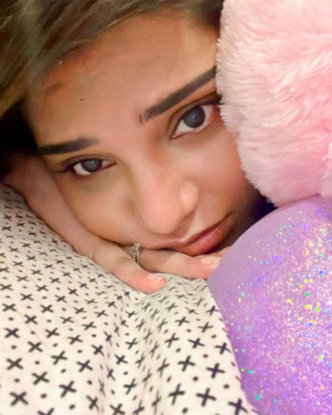 Aathmika hot photos in close up expressions on bed